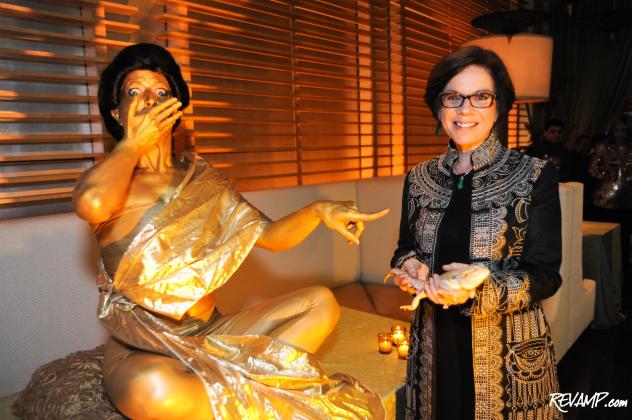Mandarin Oriental, Washington D.C. General Manager Amanda Hyndman jokes with one of the gold-painted models at yesterday's Chinese New Year celebration.